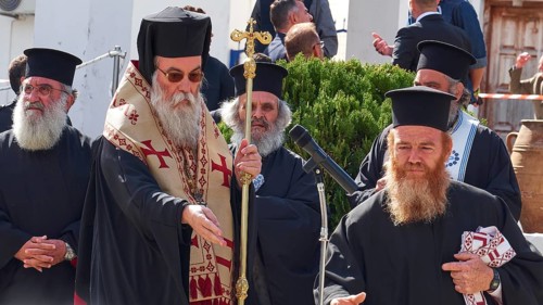 Archbishop Amphilochios, group of priests in deep black robes at an outdoor religious ceremony,