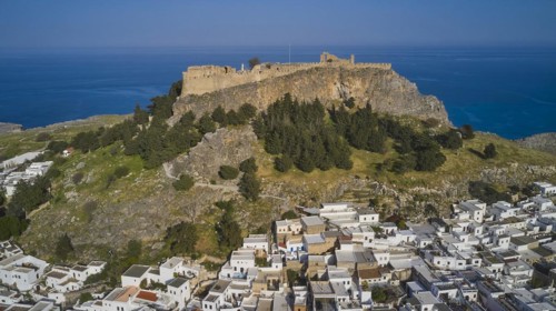 Drone shot, Lindos, Acropolis of Lindos, Late afternoon light, Old fortress above a white city with