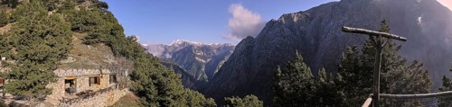 Panorama photo, snow-capped mountains, entrance to gorge, entrance, Xyloskalo, ranger, house in