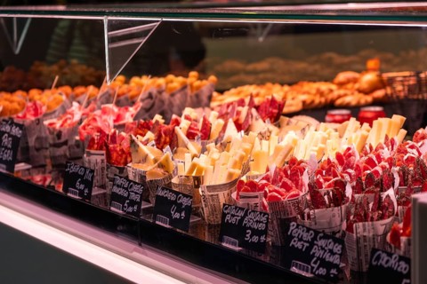 Market stall with sausage products at La Boqueria Market in Barcelona, Spain