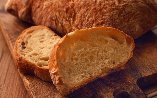 Sliced ciabatta, on a chopping board, italian bread, close-up, Italian cuisine, breakfast, no