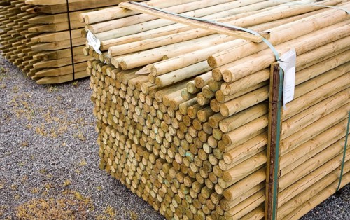 Wooden fence posts piled up in a builder's merchant yard, UK