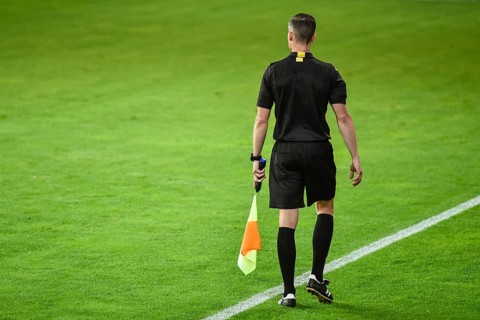 Assistant of football referee near the touchline.