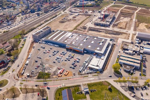 Extensive industrial area with retail, new buildings and solar cells taken from the air in an urban