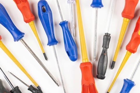 Different colorful screwdrivers on white background