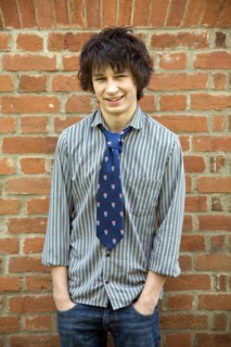 Model released teenage boy portrait casually dressed wearing shirt and tie, UK