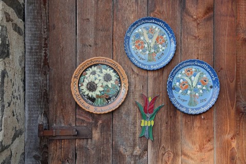 Three painted and decorative plates as award, prize, profit for at wooden door in the old town,