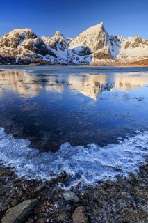Sunrise, morning light, steep mountains and fjord, ice, winter, Flakstadoya, Lofoten, Norway
