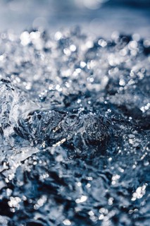 A stunning close-up of an ice surface, with light reflecting off its crystalline structure,