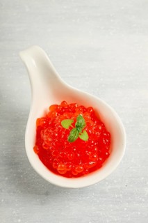 Red caviar, imitation, on a light background, close-up, no people