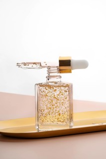 Luxurious anti-aging face serum showcased in a transparent glass bottle, enriched with visibly