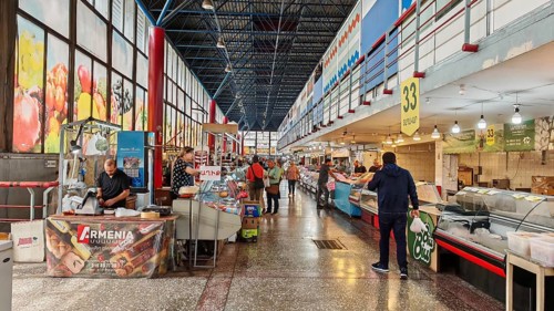 Lively indoor market with various stands and visitors, Armenia