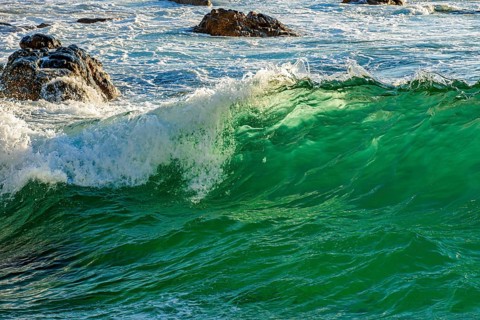 Wave breaking between the rocks on the beach in the city of Salvador in Bahia, Salvador, Bahia,