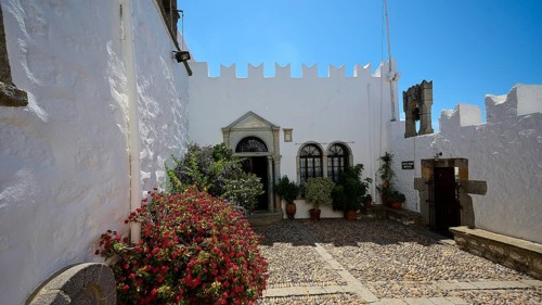 Courtyard with white walls, flower pots and flowering plants, Zoodochou Pigis Monastery, The