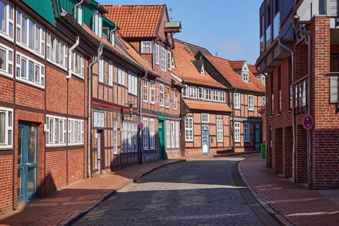 Old half-timbered houses and brick buildings along a street in the historic centre of Stade,
