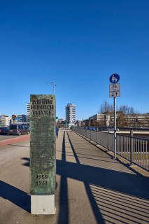 Footpath and cycle path, metal railing, general architecture, stele with explanations of the