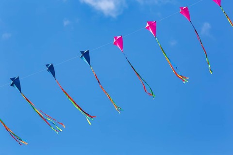Strung kites flying in the blue sky, garland, kite festival in Vinsebeck, Steinheim, Eggegebirge