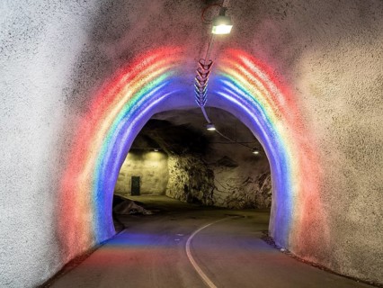 Colorful illuminated tunnel for bicycles and pedestrians leads up to Hardanger suspension bridge,