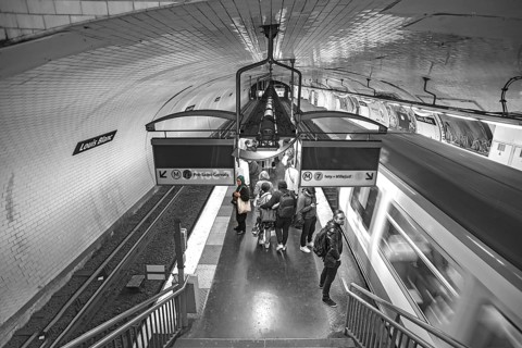 Louis Blanc metro station with incoming metro, black and white, Paris, France
