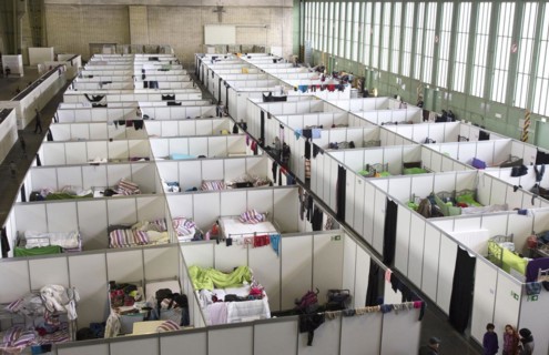 Temporary rooms with beds are set up in an emergency shelter for refugees on 9 December 2015 in a