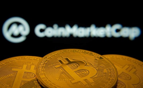 Dhaka, Bangladesh- 27 March 2025: Close-up of Bitcoin coins with the Coinmarketcap logo visible on