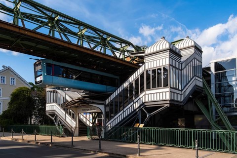 A suspension railway leaves the Völklinger Straße stop in Wuppertal, Germany