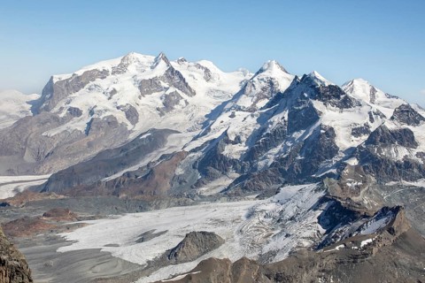 Majestic view of the snow-capped peaks of the Swiss Alps in Zermatt during summer. The rugged