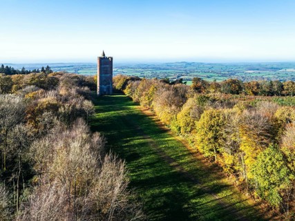 Autumn over Alfred's Tower from a drone, Stourhead, Somerset, England, United Kingdom