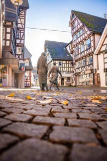 Street through the half-timbered town with art figures, Calw, Black Forest Germany