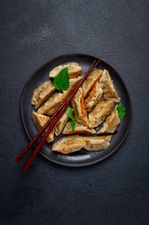 Japanese fried gyoza dumplings, with pork, sesame seeds, green onions