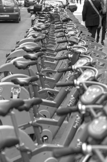 City rental bikes lined up on the side of the road, black and white, Paris, France