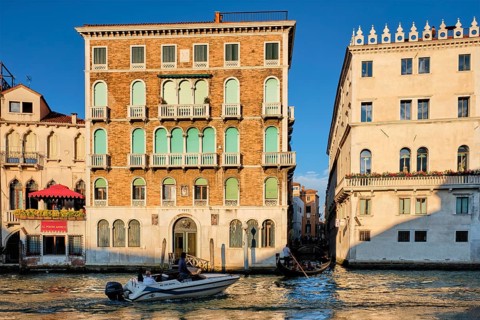 VENICE, ITALY, JUNE 27, 2018: Grand Canal with boats and gondolas on sunset, Venice, Italy