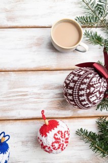Christmas or New Year composition. Decorations, knitted balls, fir and spruce branches, cup of