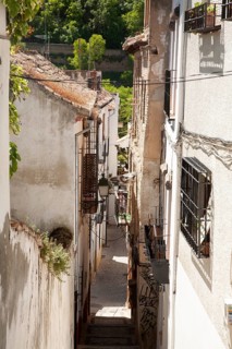 Narrow alleyway named Candil in the Moorish housing district of Albaicin, Granada, Spain