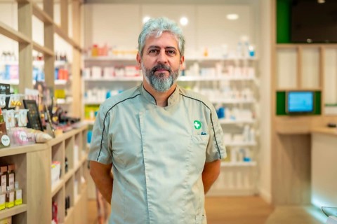 Portrait of the owner of a pharmacy standing arms on back in the store