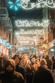 Busy street with Christmas lights and crowds, New Year's Eve London, United Kingdom