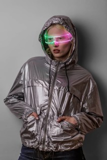 A woman wearing neon-lit glasses and a reflective jacket, embodying a futuristic and high-tech