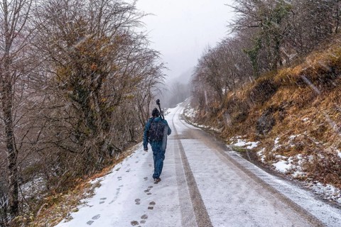 A young photographer walking in the aizkorri mountain of gipuzkoa. Snowy landscape by winter snows.