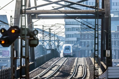 ICE en route on a railway bridge with tracks and signalling system. Mannheim, Baden-Württemberg,