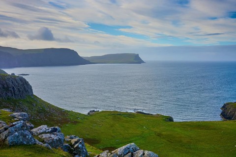 Wide coastal landscape with blue sea and cloudy sky, Waterstein Head, Waterstein, Isle of Skye,