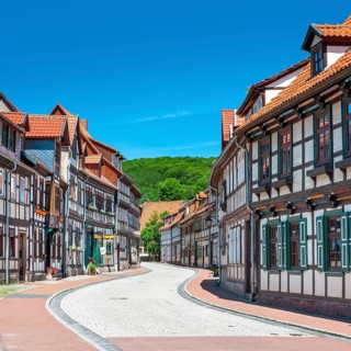 Street with half-timbered houses and cobblestones winds through the old town, Stolberg im Harz,