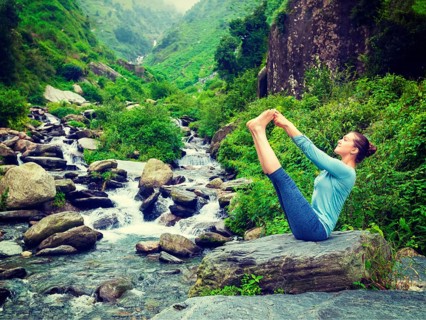 Yoga exercise outdoors, panorama of woman doing Ashtanga Vinyasa Yoga balance asana Ubhaya