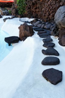 Black lava stones, decoration at the swimming pool, Jameos del Agua, Lanzarote, Spain