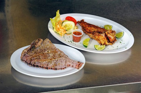In restaurant left in Caribbean invasive lionfish (Pterois miles) prepared for kitchen without head