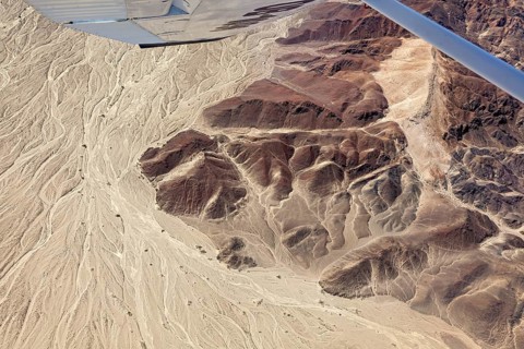 Sandy and dry landscape from the air with visible geoglyphs, the geoglyphs and images in the desert