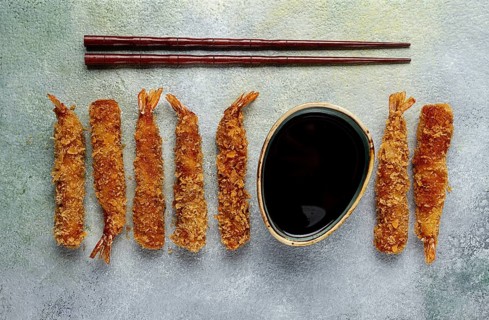 Fried shrimp, peeled in tempura, soy sauce, close-up