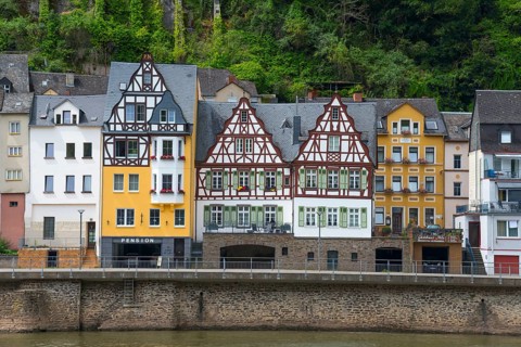 Half-timbered houses and colourful historic buildings on the banks of the river in a green,