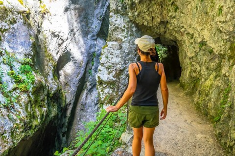 Woman enjoying a summer day while wandering through the stunning tolmin gorge in slovenia,