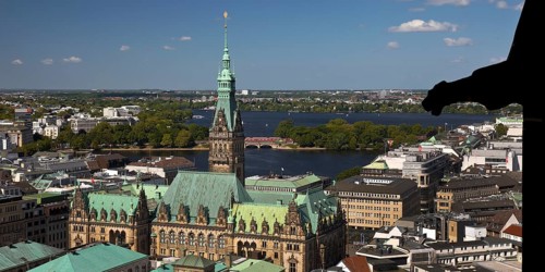 City view from above from the tower of the St. Nikolai memorial with the town hall and the Alster,