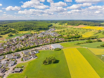 View of a village and surrounding fields and forests under a blue sky with clouds, Gechingen, Black